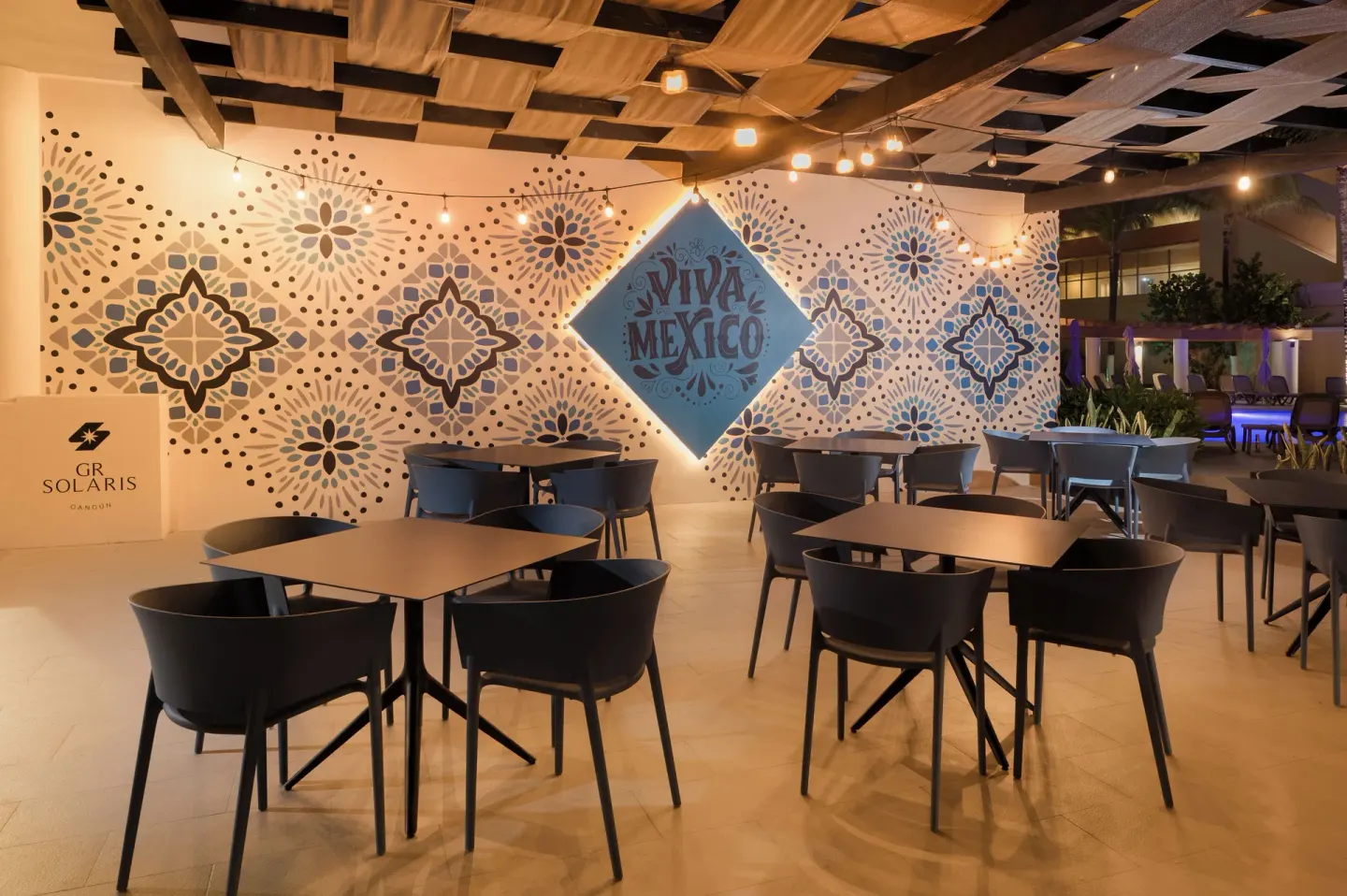Outdoor Mexican-themed dining terrace with mural seating at GR Solaris Cancun & Spa.