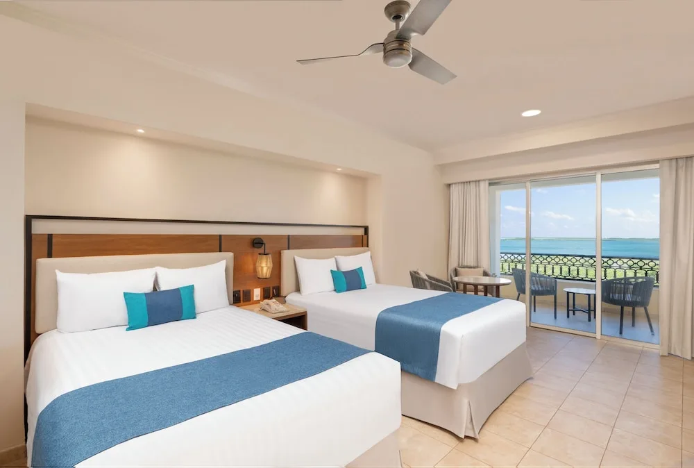 Deluxe Room with two beds and ocean-view balcony at GR Solaris Cancun & Spa.