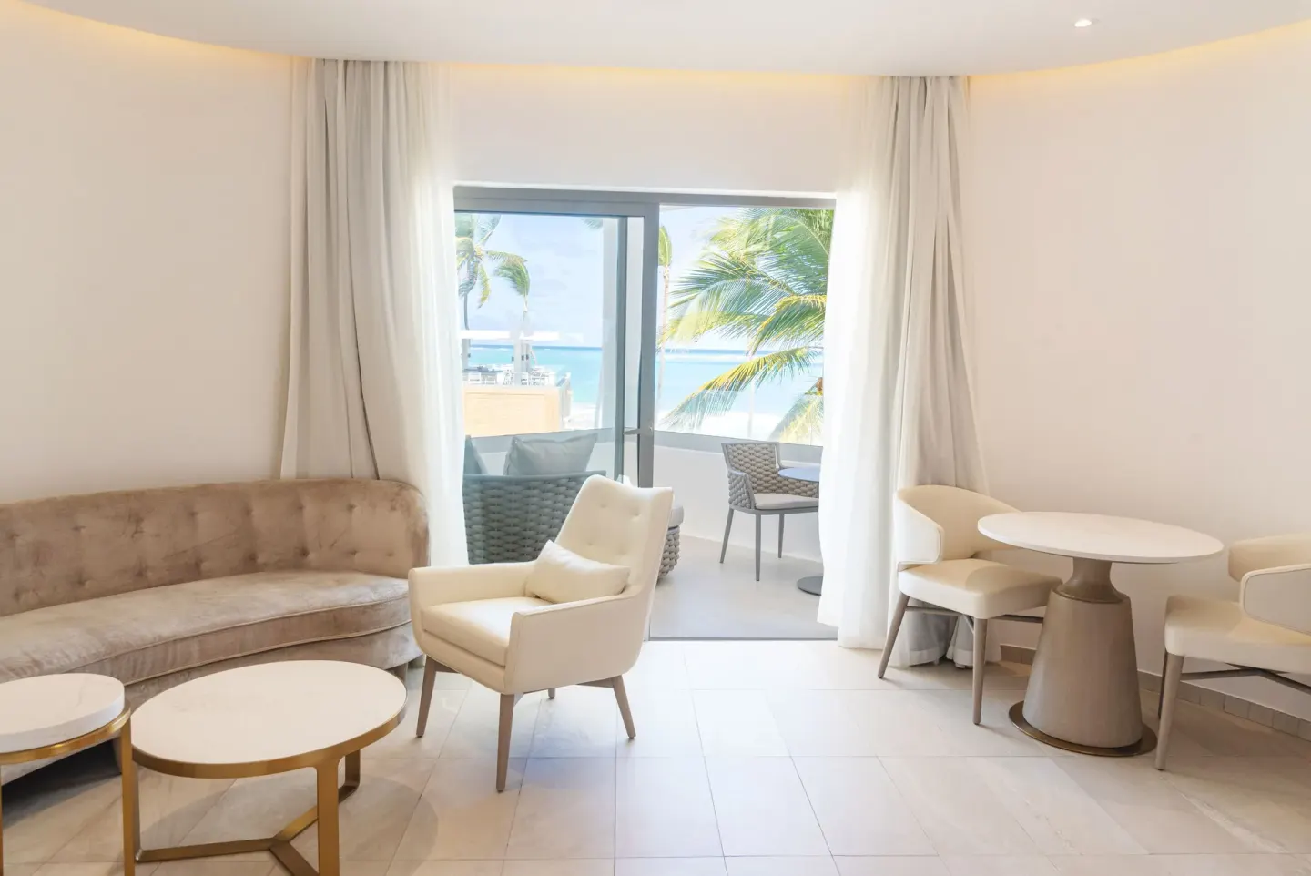 Oceanfront suite sitting area with balcony seating at Grand Bavaro Princess.