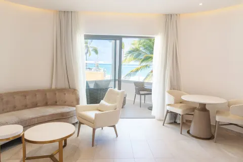 Oceanfront suite sitting area with balcony seating at Grand Bavaro Princess.