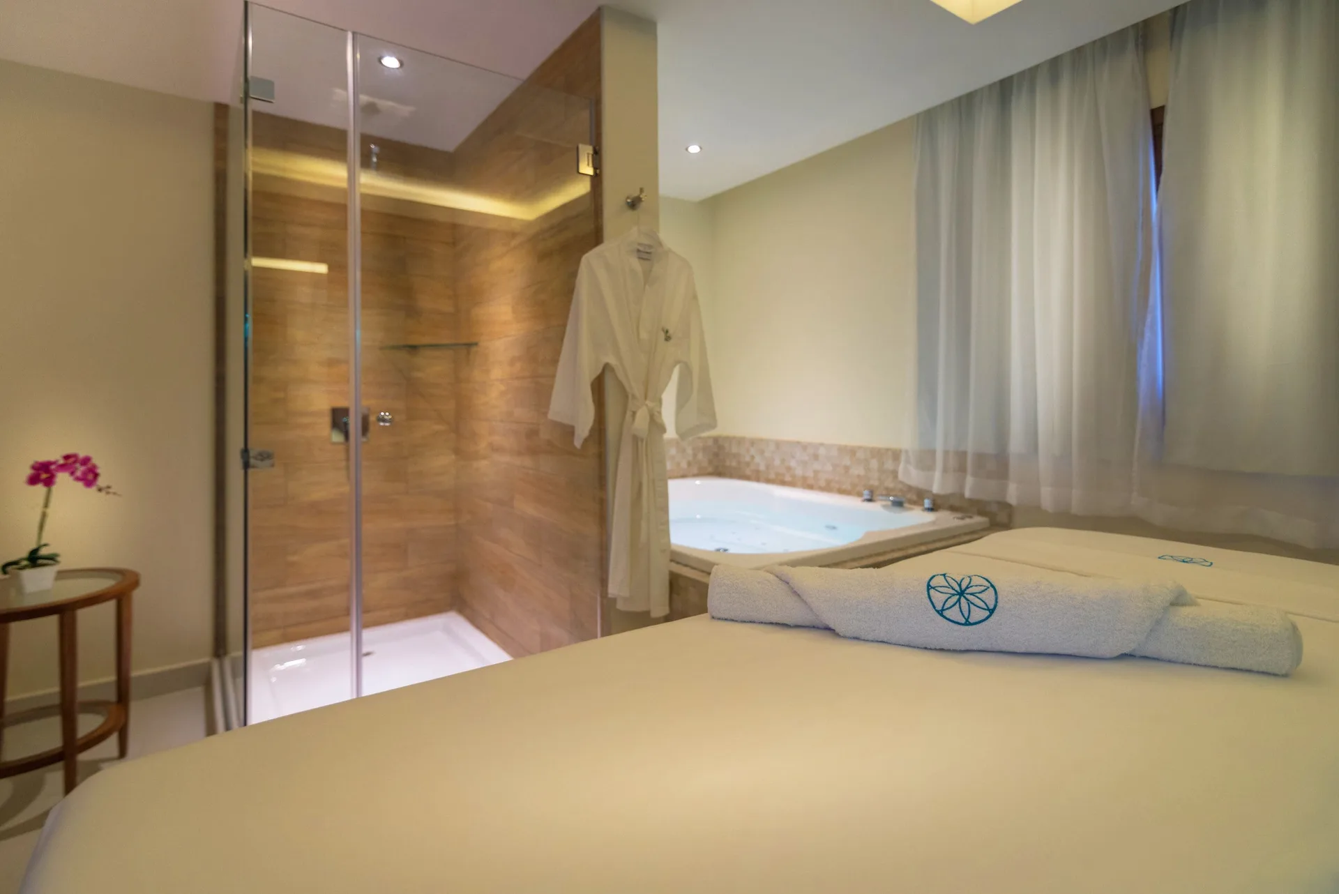 Spa treatment room with massage bed, shower and tub at Grand Bavaro Princess.