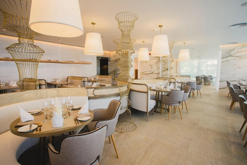 Bright restaurant with marble walls and sculptural dividers at Grand Bavaro Princess.