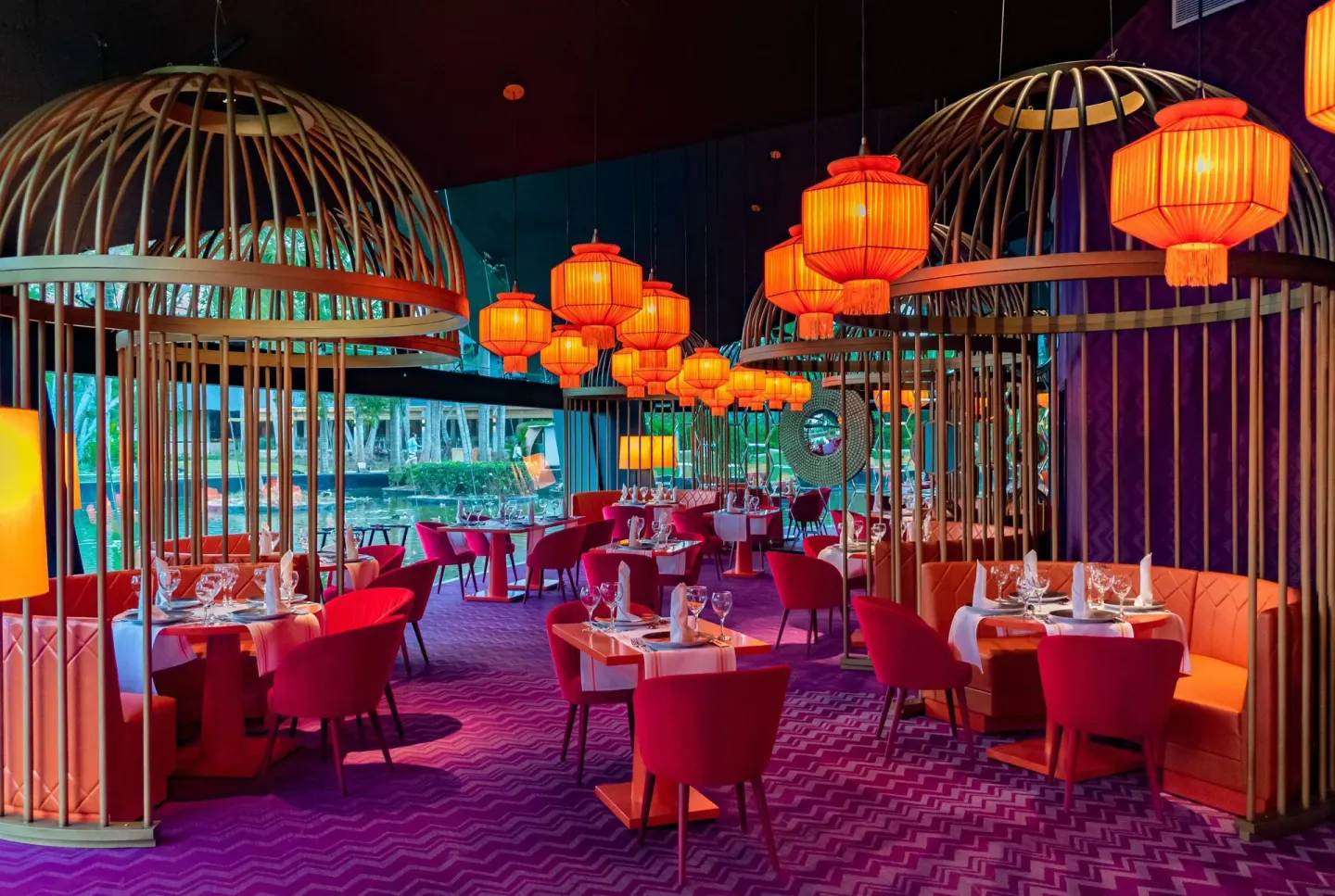 Colorful restaurant dining room with red chairs and lanterns at Grand Bavaro Princess.