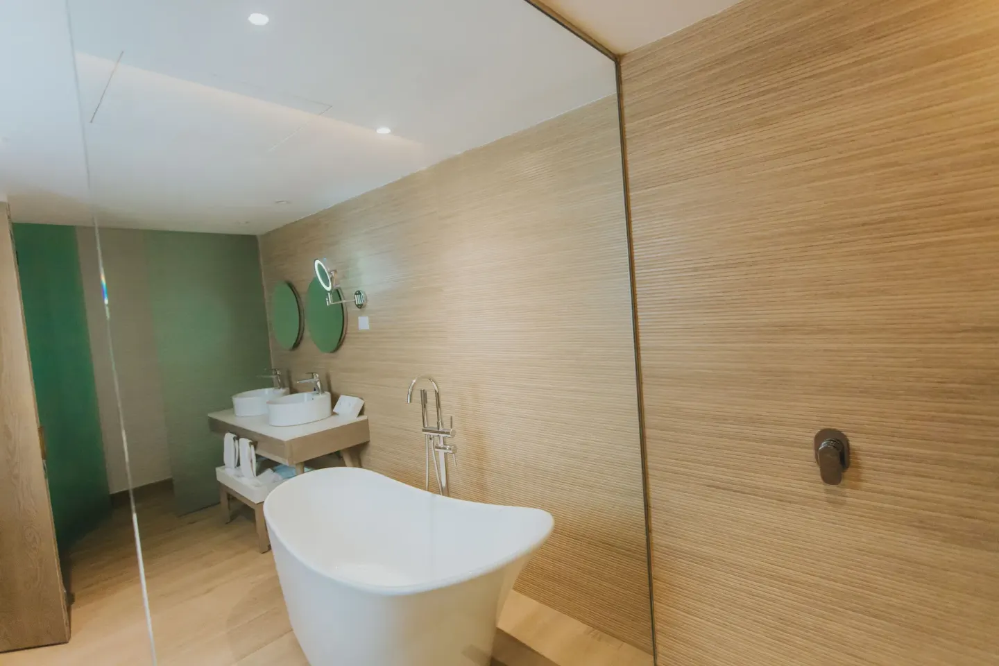 Bungalow bathroom with freestanding tub and glass shower at Grand Bavaro Princess.