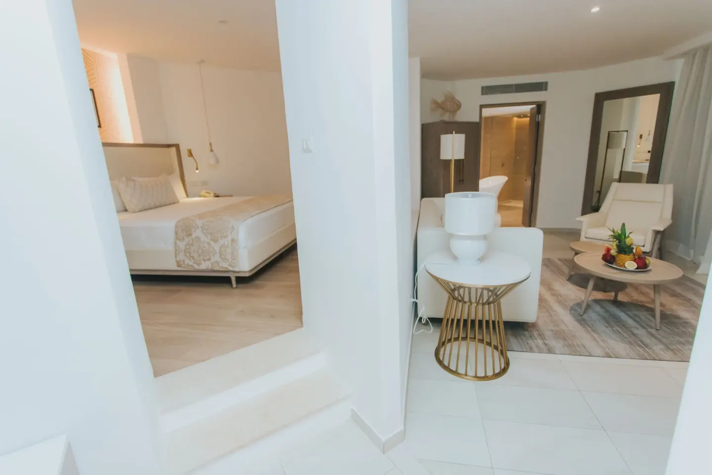 Bungalow bedroom and living area separated by columns at Grand Bavaro Princess.