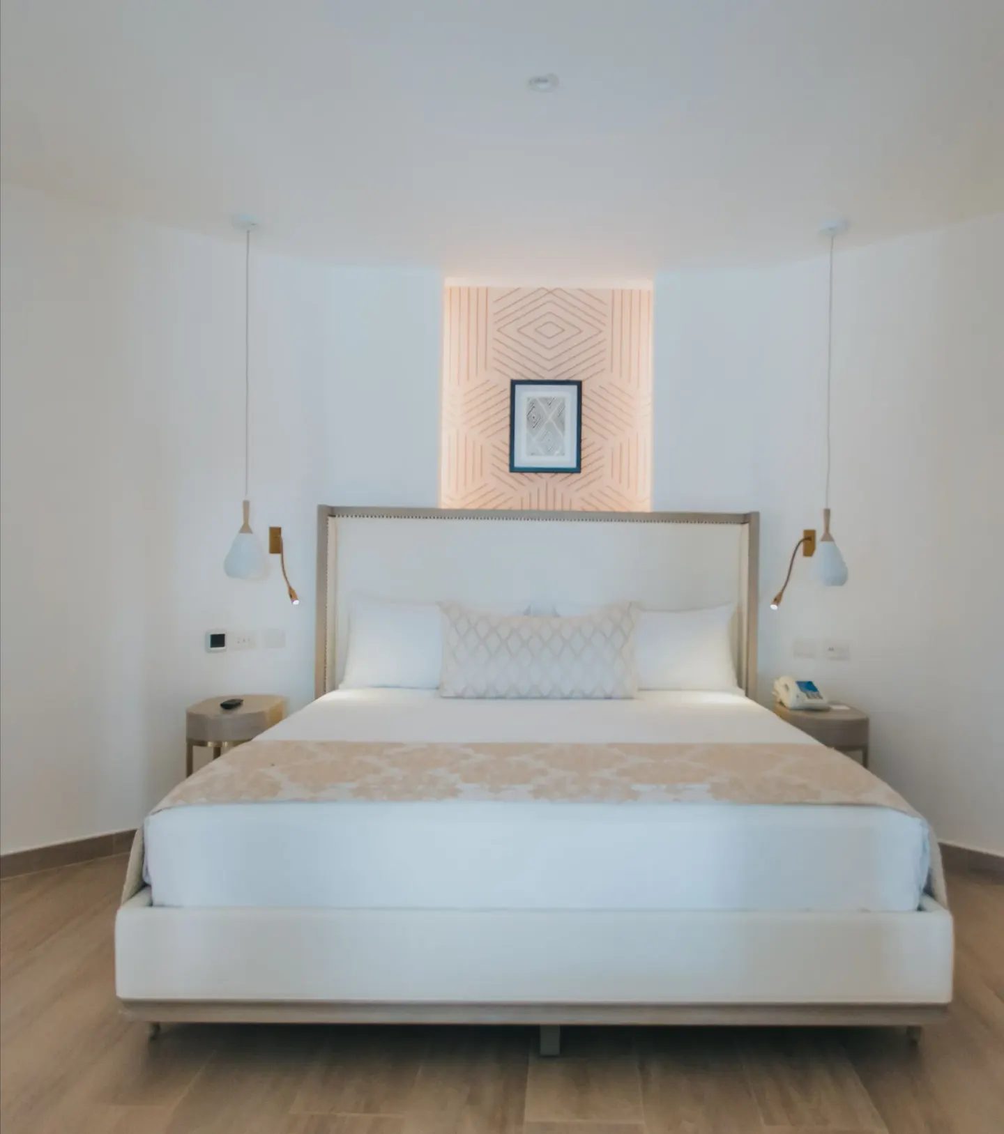 Front view of bungalow king bed with hanging lamps at Grand Bavaro Princess.