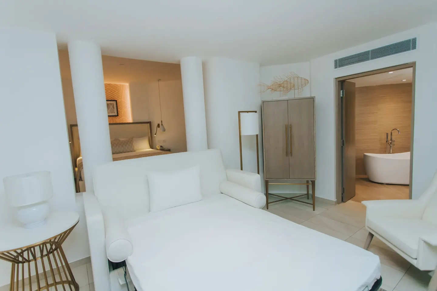 Bungalow sofa bed area with bathroom doorway at Grand Bavaro Princess.
