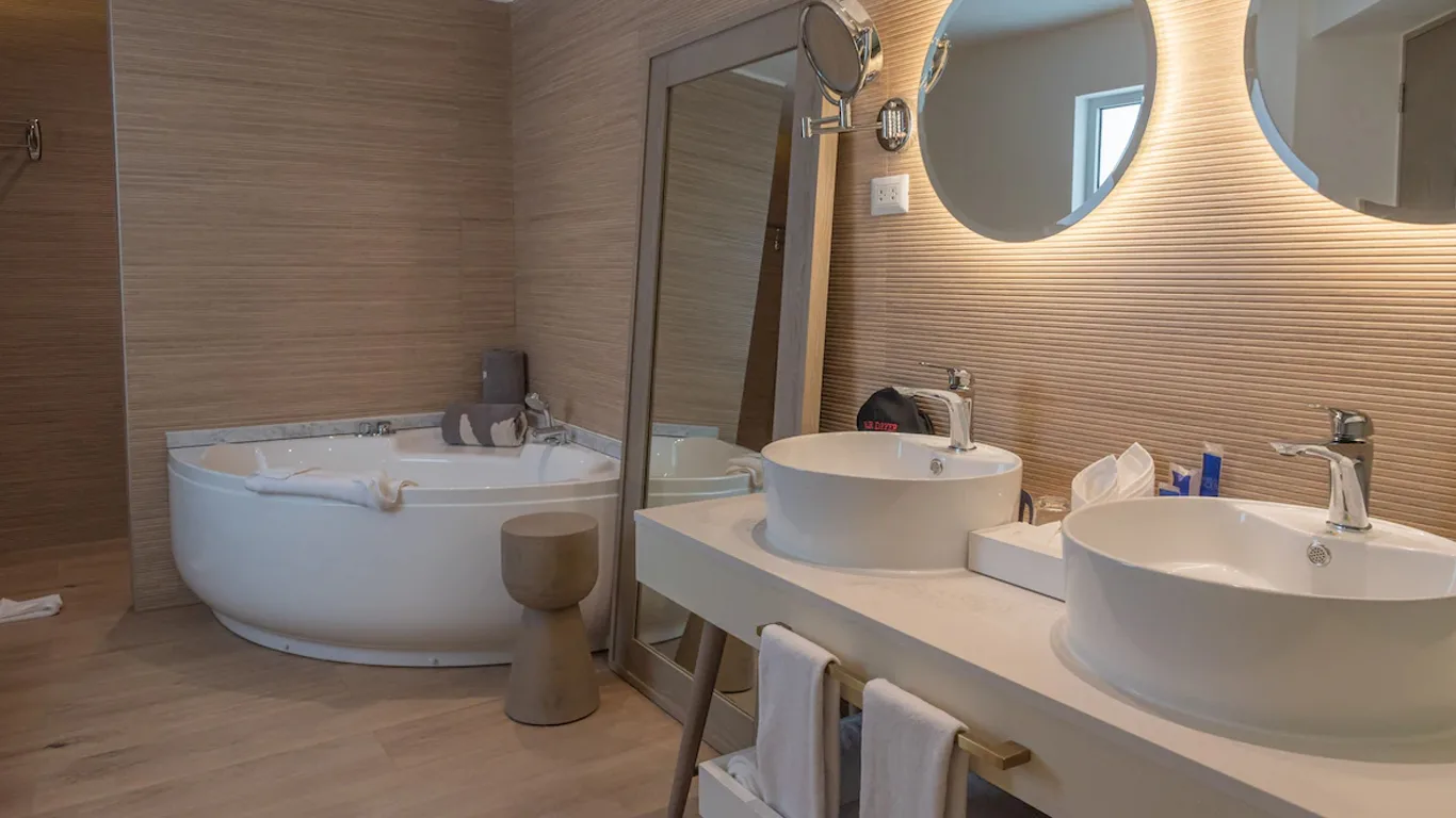 Honeymoon Platinum Suite bathroom with corner hydromassage tub and double vanity at Grand Bavaro Princess.