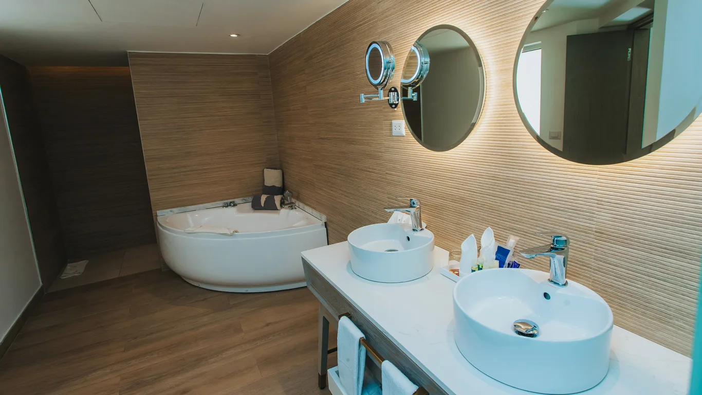 Platinum Suite bathroom with corner hydromassage tub and double vanity at Grand Bavaro Princess.
