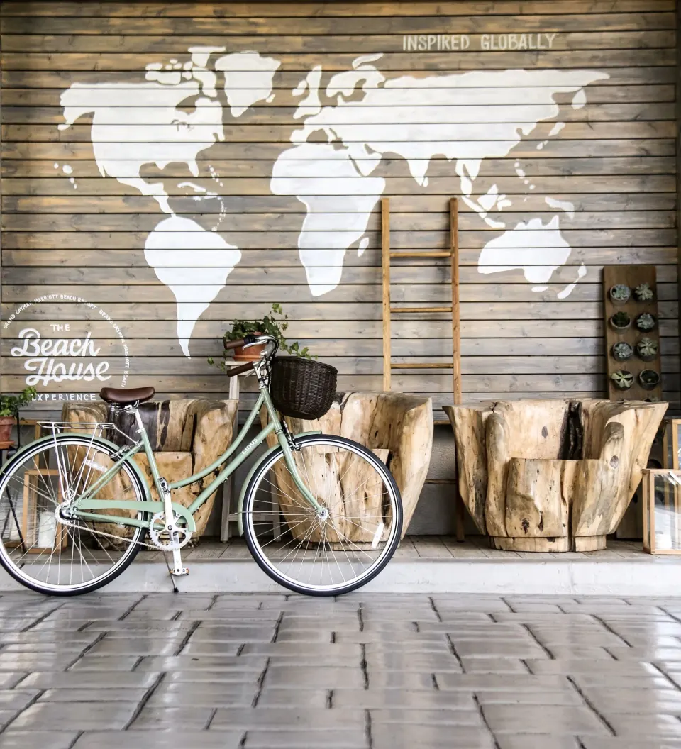 Bicycle in front of a wood wall with a world map at Grand Cayman Marriott Resort.