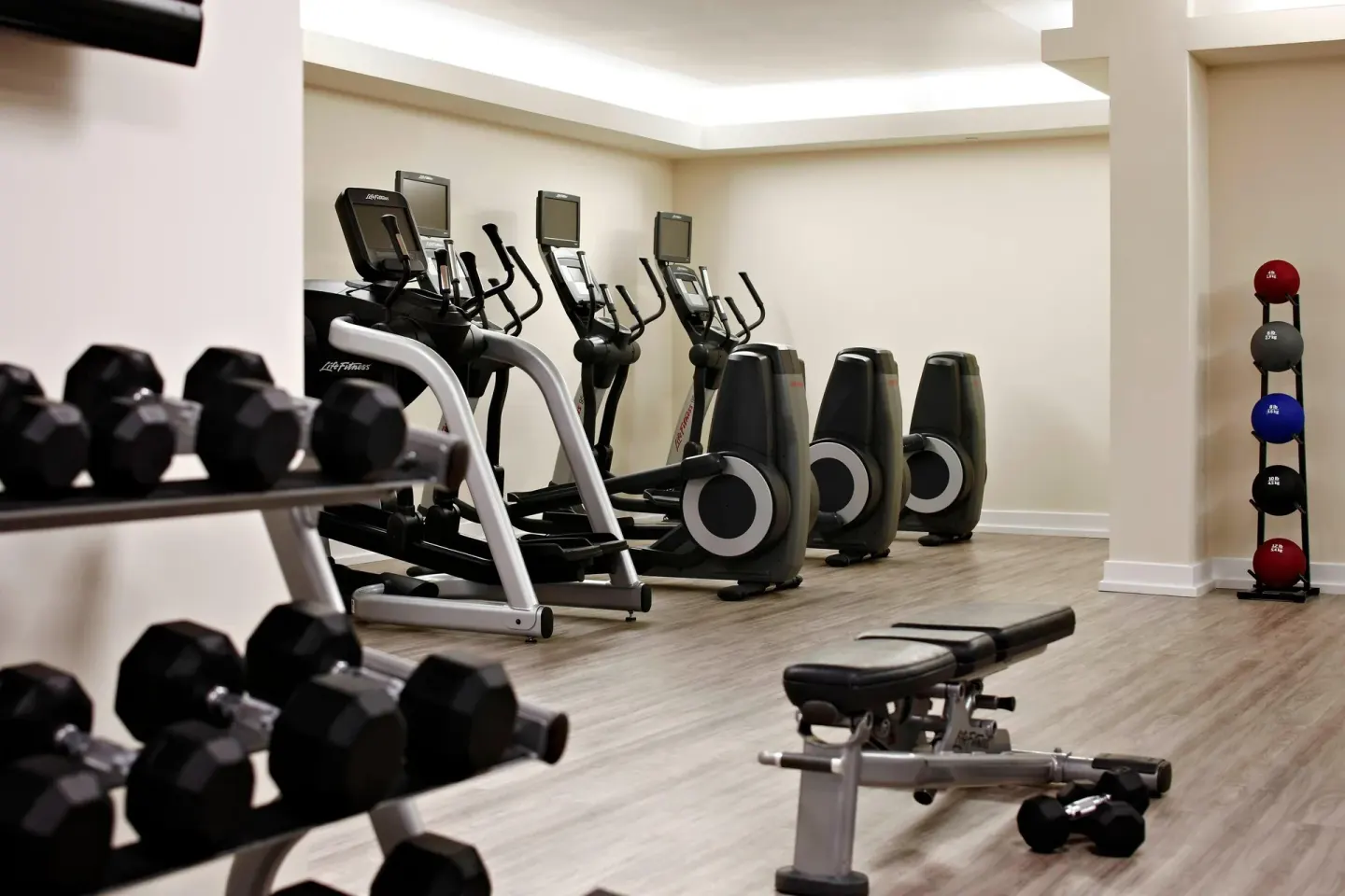 Fitness room with cardio machines and weights at Grand Cayman Marriott Resort.