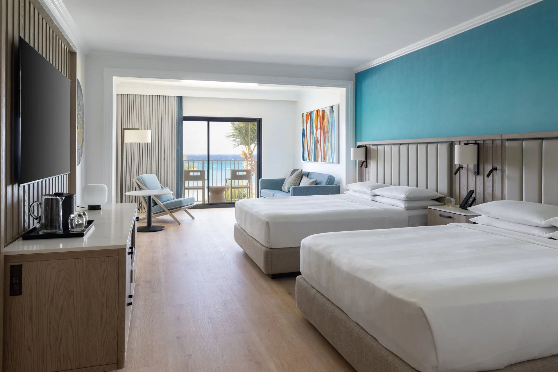 Ocean-view guest room with two queen beds at Grand Cayman Marriott Resort.