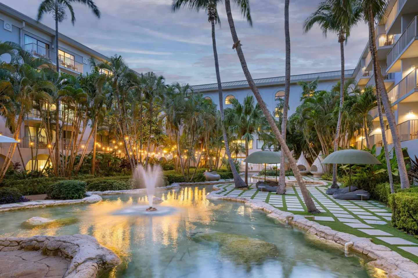 Palm-filled courtyard with a fountain pool at Grand Cayman Marriott Resort.