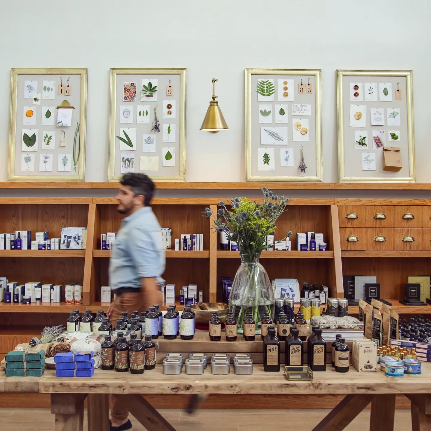 Retail display with bottles, boxes, flowers and botanical wall art at Grand Cayman Marriott Resort.