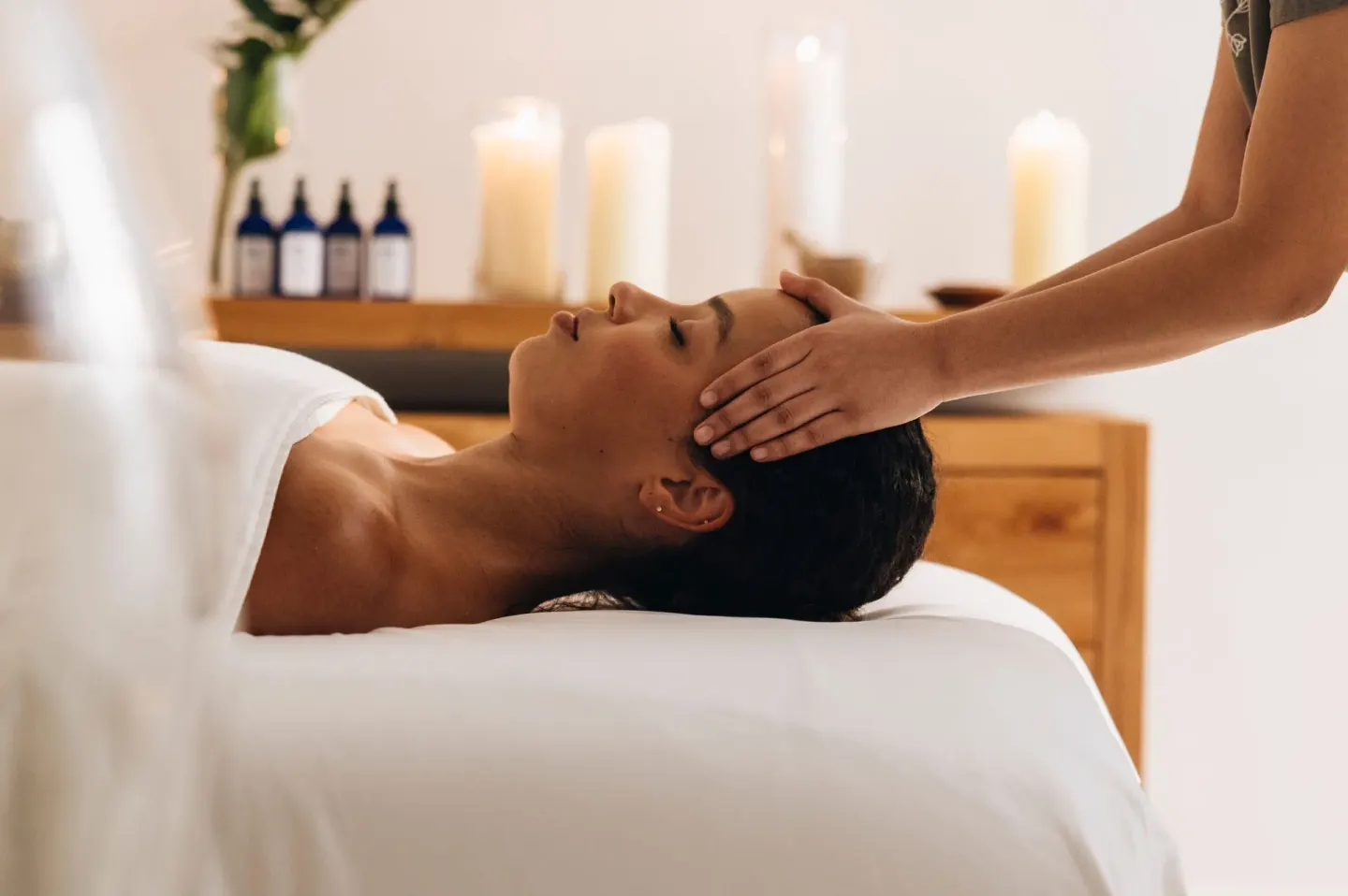 Guest receives a scalp massage in a candlelit spa room at Grand Cayman Marriott Resort.