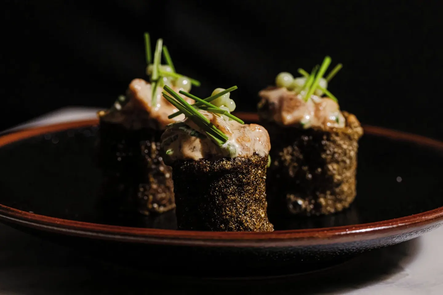 Sushi-style bites on a dark plate at Grand Cayman Marriott Resort.