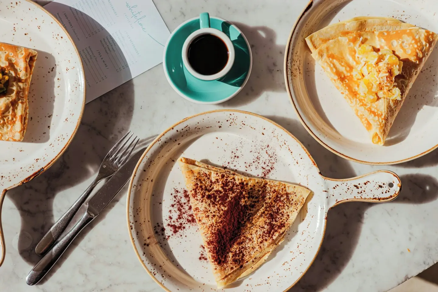 Crepes and coffee on a marble table at Grand Cayman Marriott Resort.