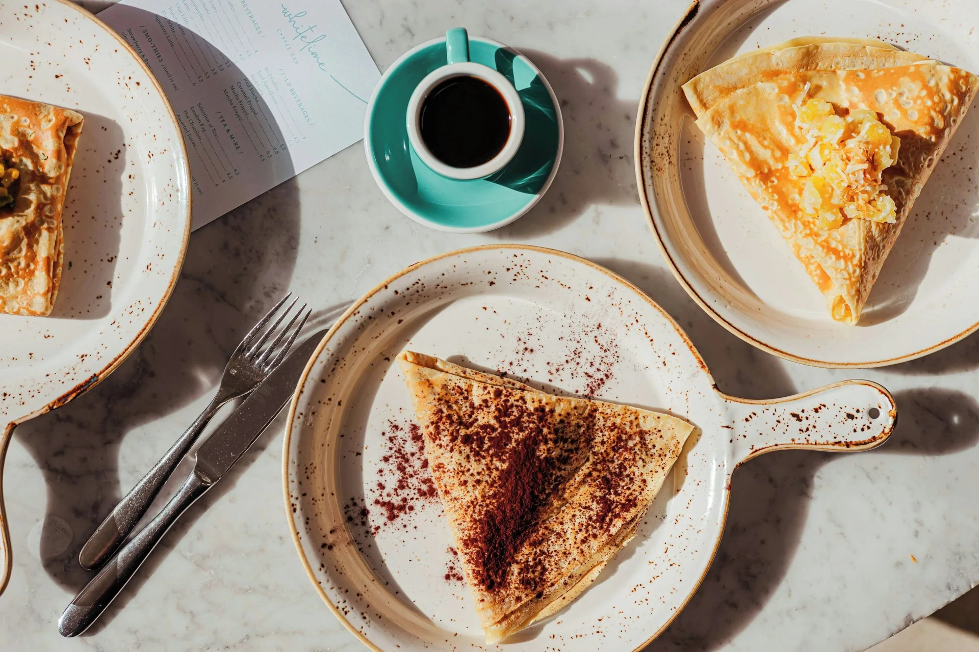 Crepes and coffee on a marble table at Grand Cayman Marriott Resort.