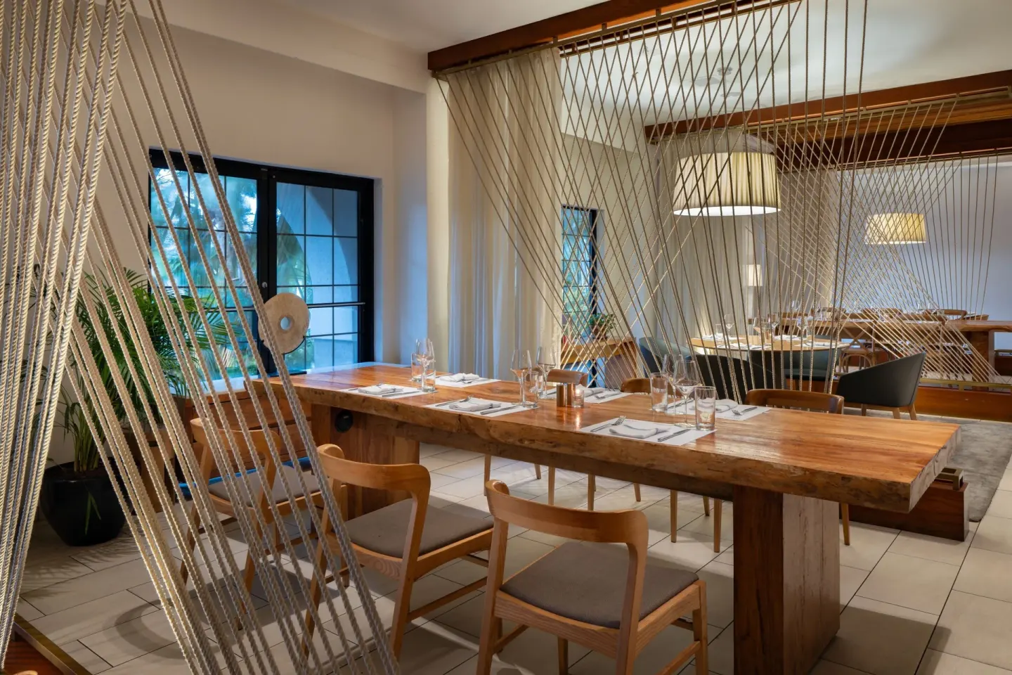 Dining room with rope dividers and wooden tables at Grand Cayman Marriott Resort.