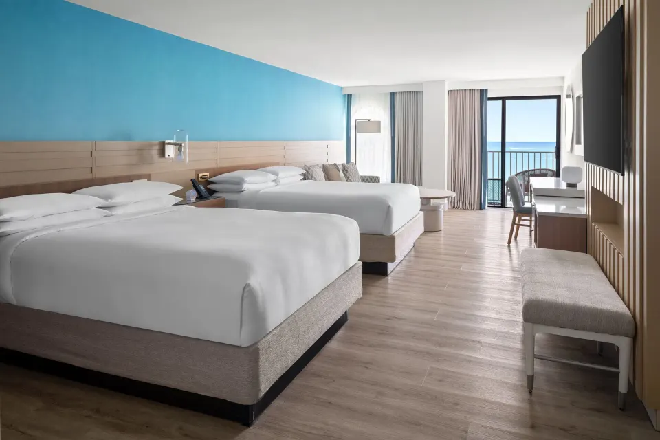 Grand Room Oceanfront with two beds and balcony view at Grand Cayman Marriott Resort.