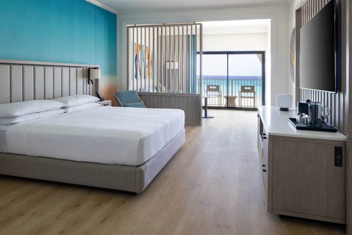 Junior suite king bed and balcony view at Grand Cayman Marriott Resort.