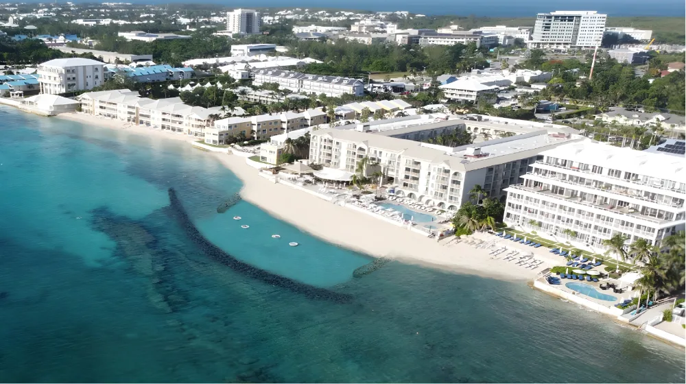 Aerial view of the beachfront and clear water at Grand Cayman Marriott Resort.