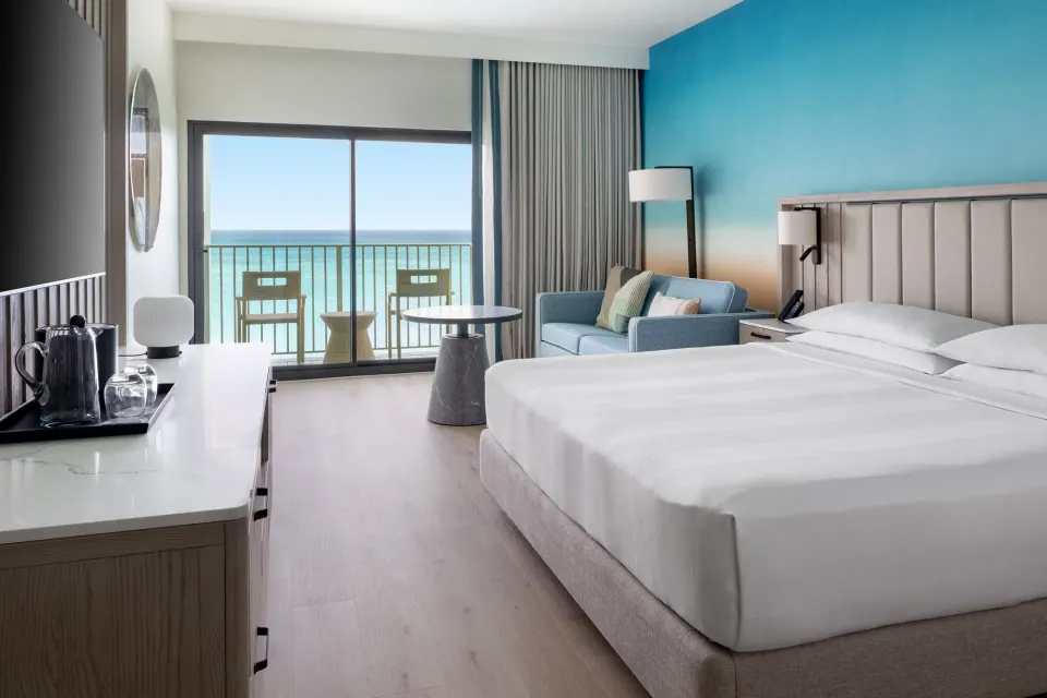 Oceanfront king room with sofa bed and balcony at Grand Cayman Marriott Resort.