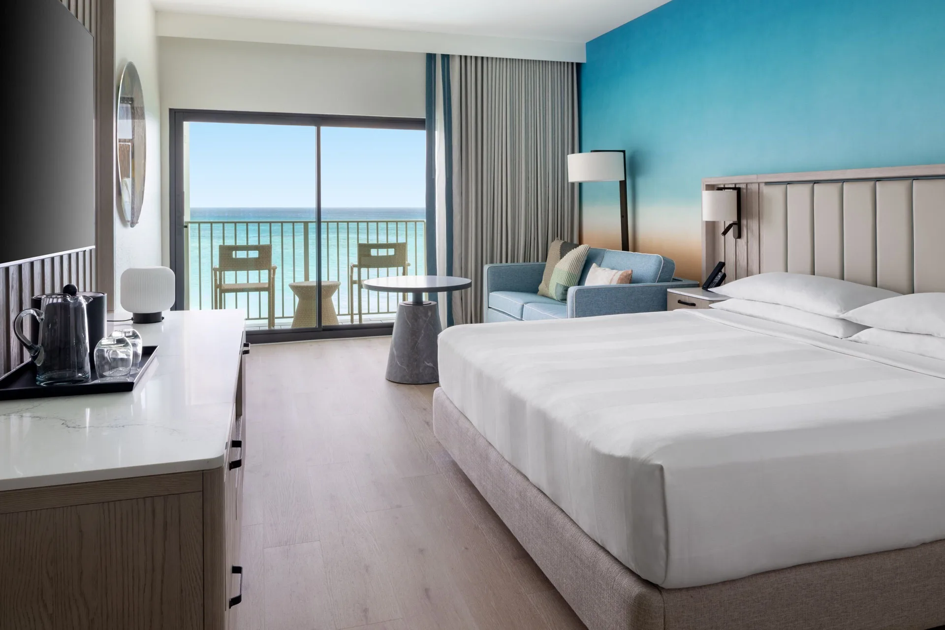Grand Room with Sofa Bed Oceanfront at Grand Cayman Marriott Resort with king bed, sofa sleeper, and direct Caribbean Sea views.