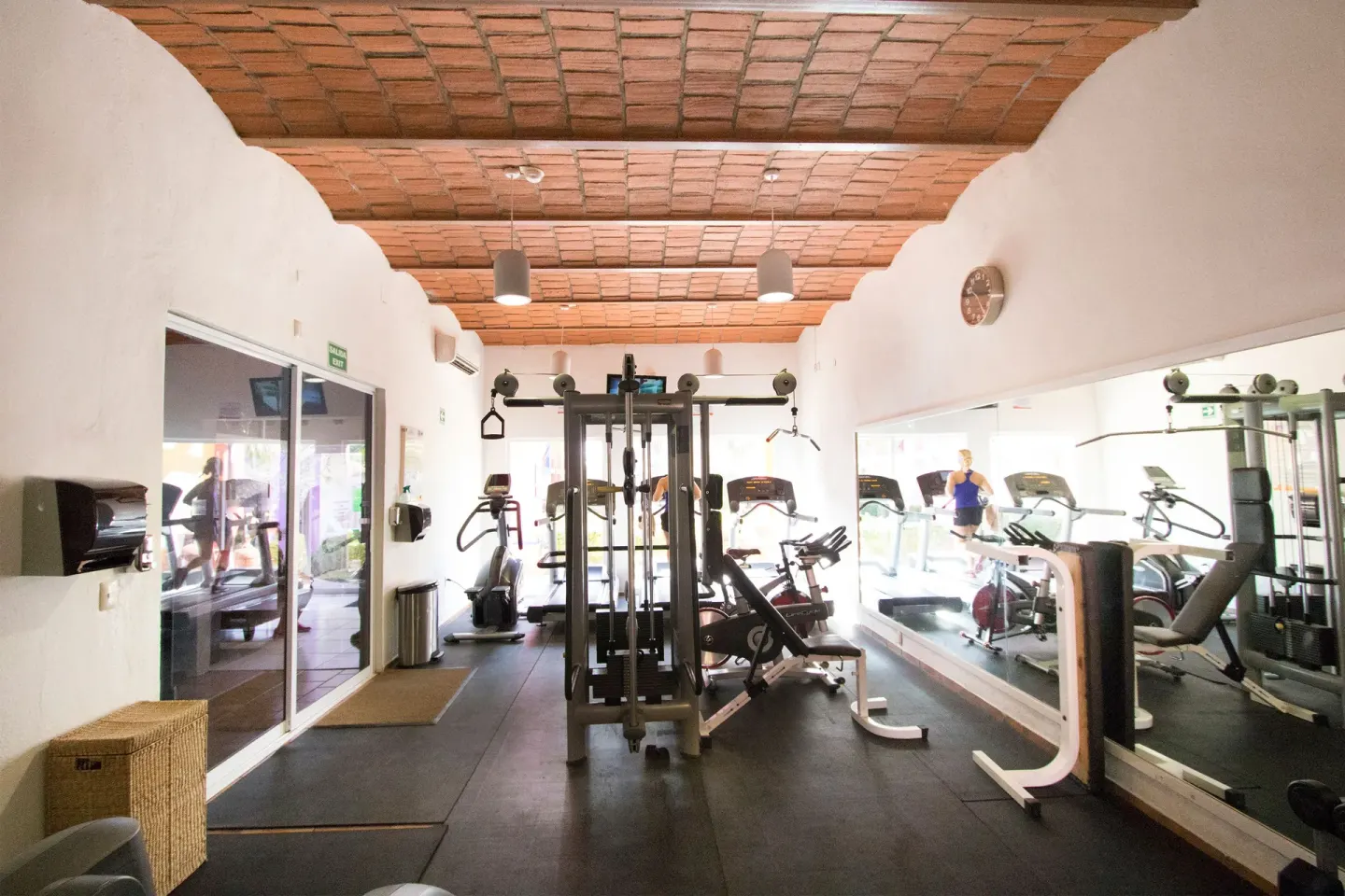 Fitness room with cardio and weight equipment at Grand Decameron Complex Bucerias.