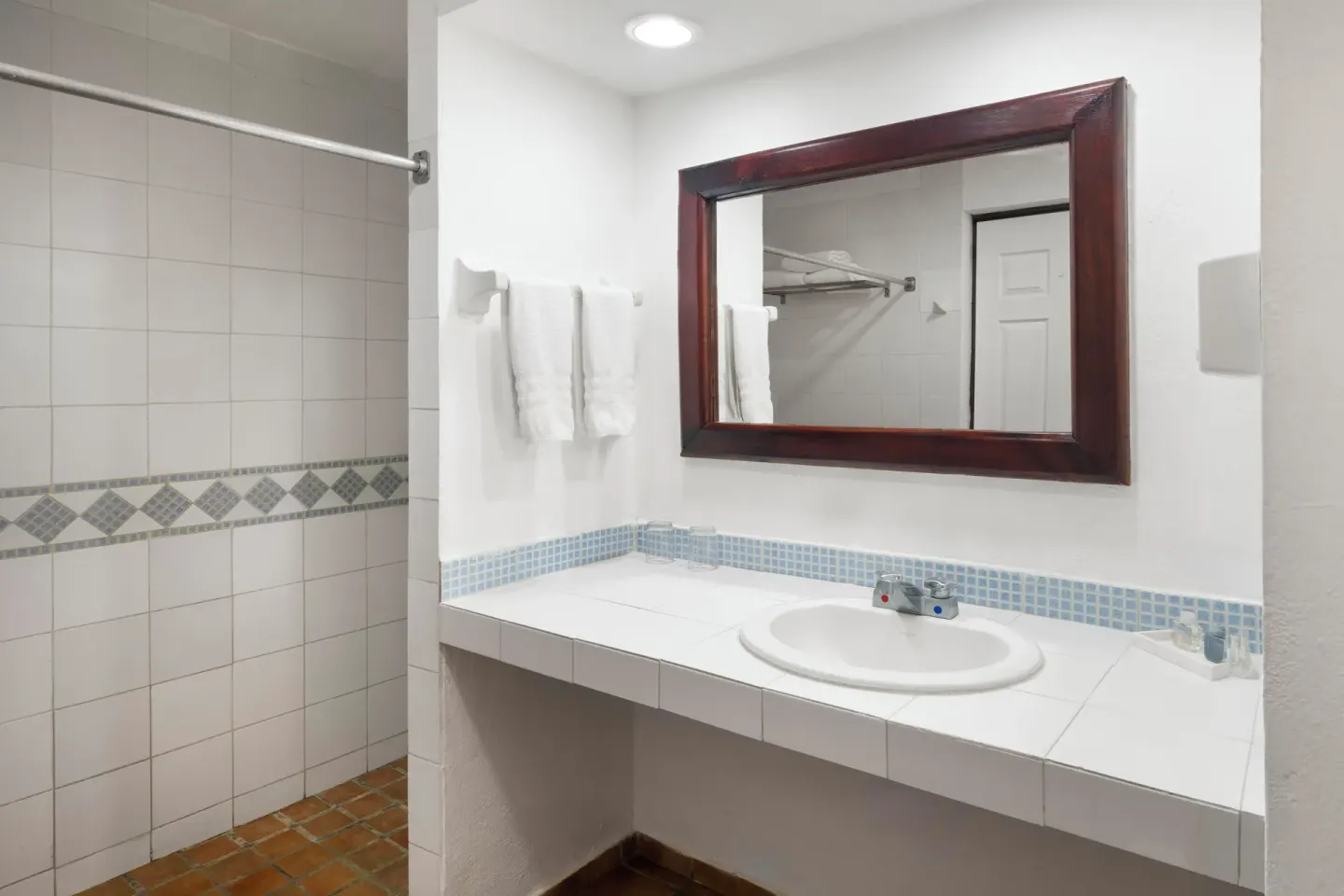 Bathroom vanity and tiled shower area at Grand Decameron Complex Bucerias.
