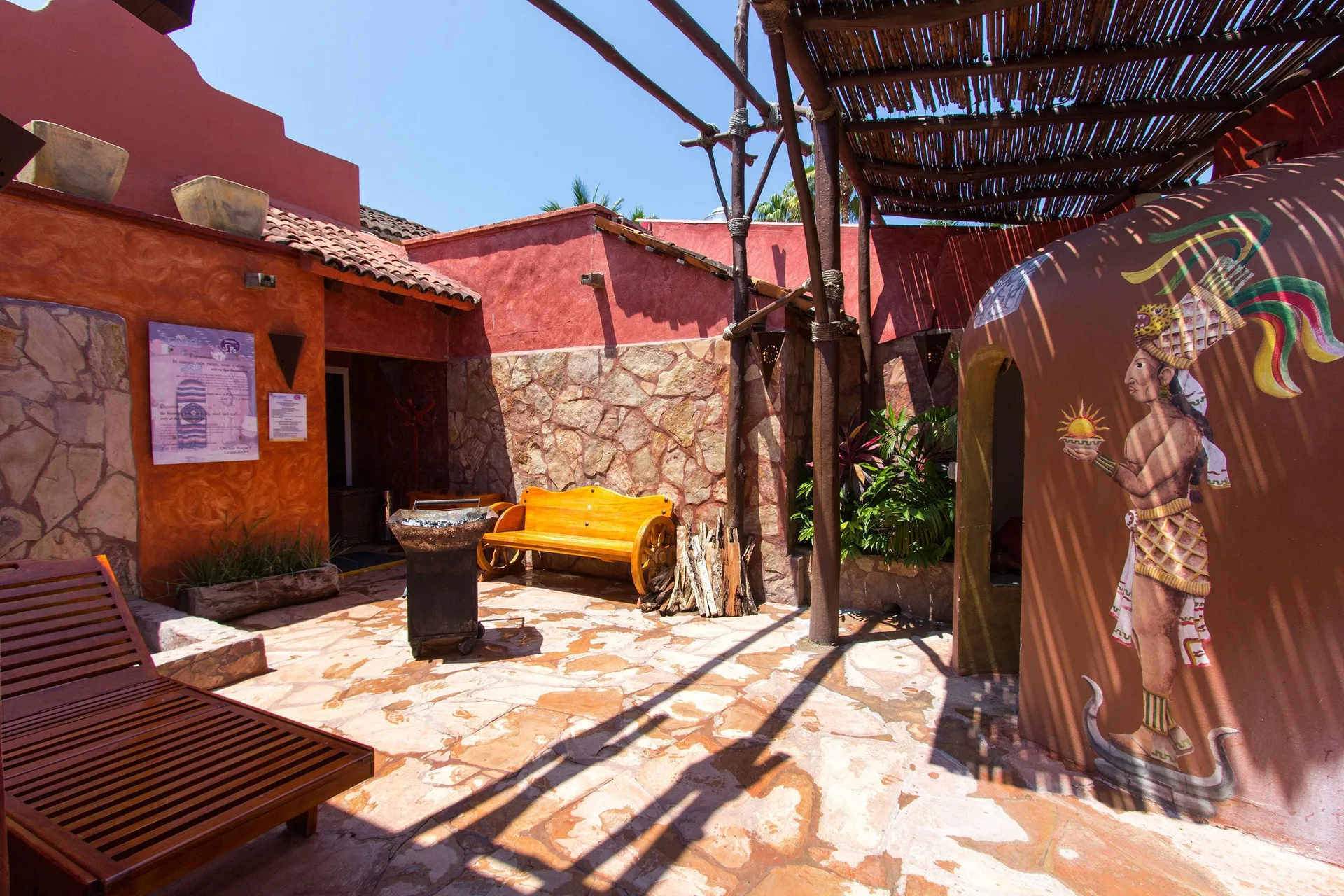 Colorful spa courtyard with benches and mural at Grand Decameron Complex Bucerias.