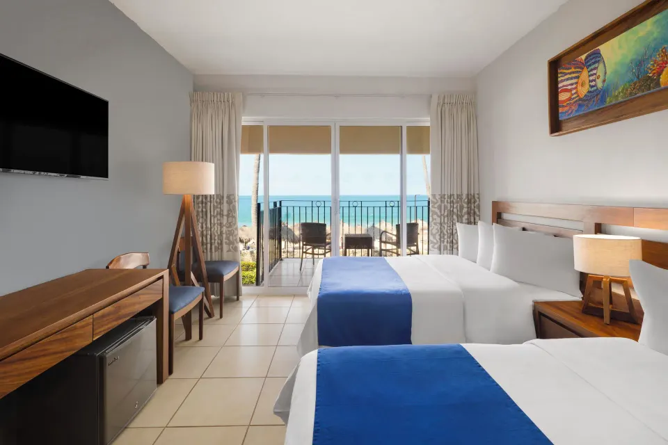 Ocean View Room with two beds and balcony facing the sea at Grand Decameron Complex Bucerias.
