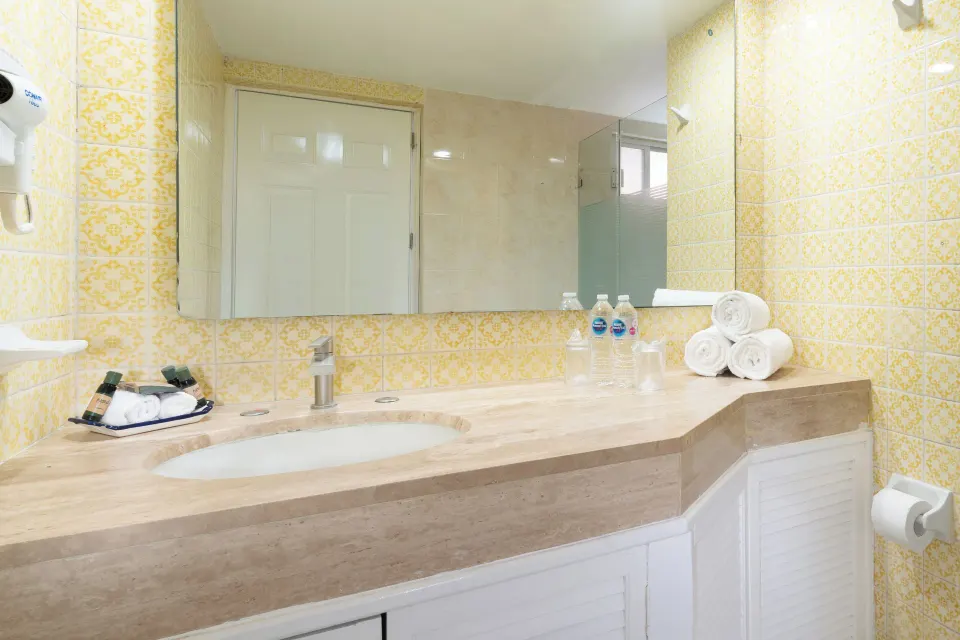 Oceanfront room bathroom vanity with towels at Grand Decameron Complex Bucerias.