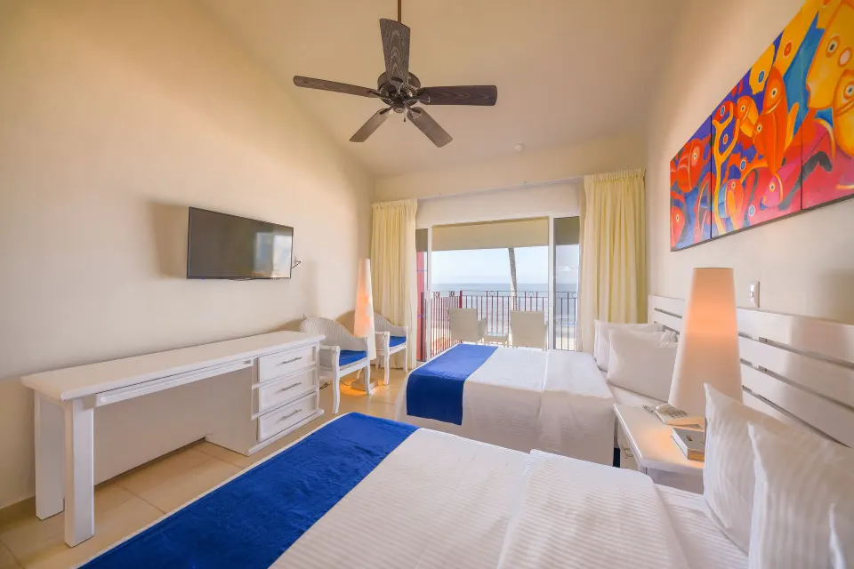 Oceanfront room with two beds and balcony view at Grand Decameron Complex Bucerias.