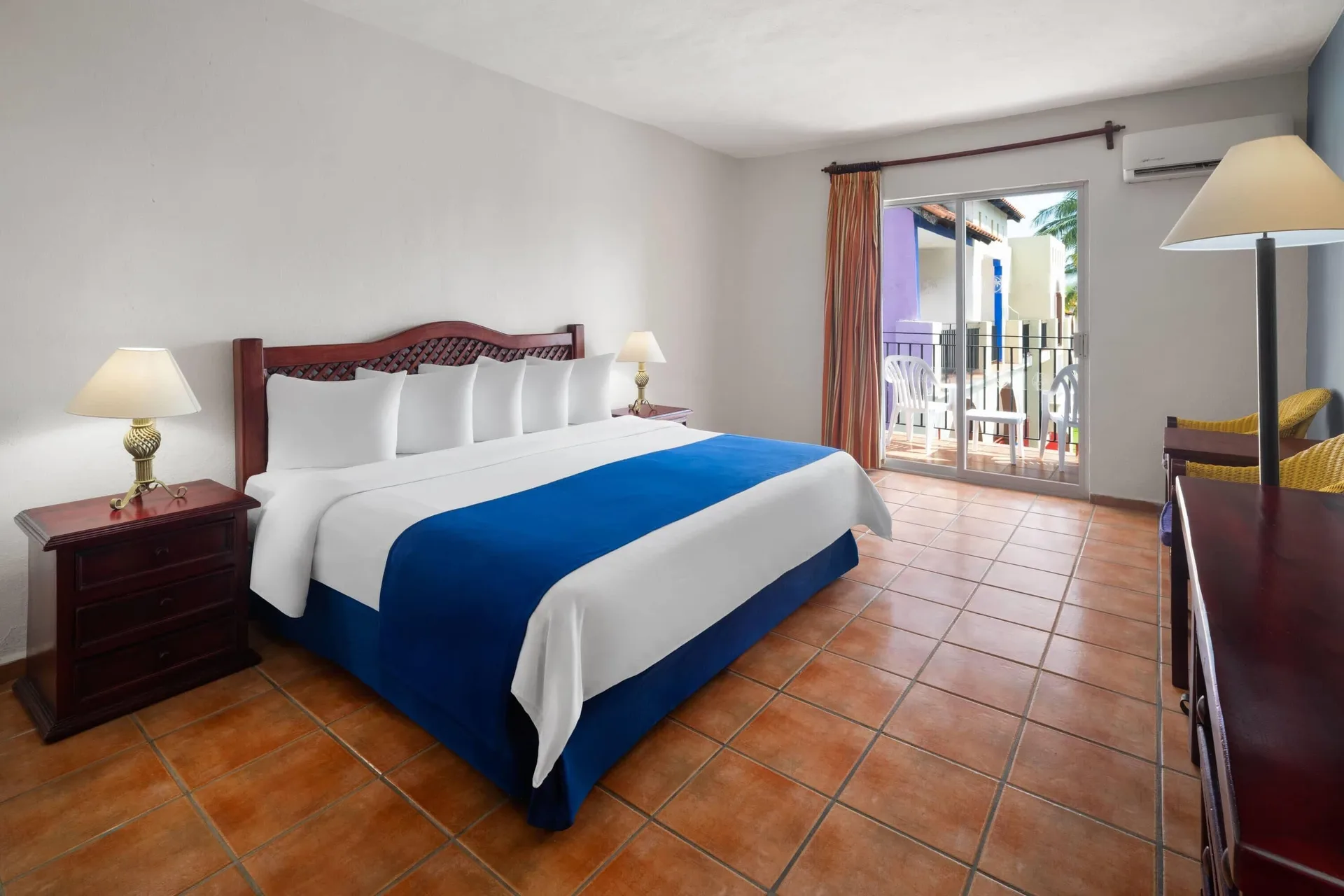 Standard Room king bed and balcony at Grand Decameron Complex Bucerias.