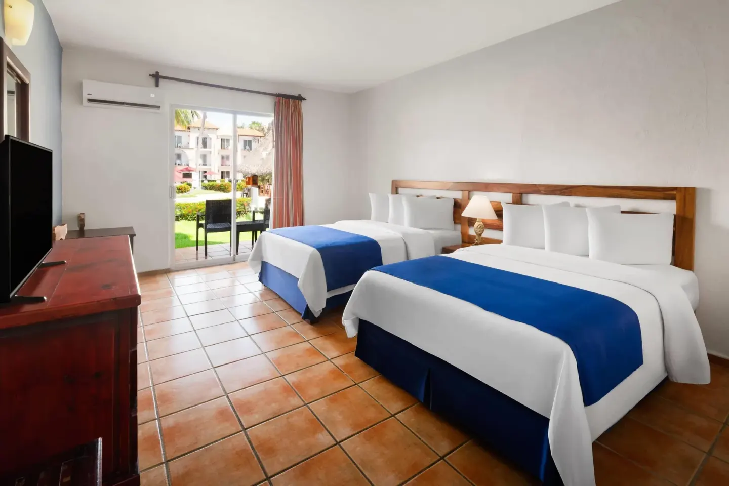 Standard Room with two beds and garden-facing patio at Grand Decameron Complex Bucerias.
