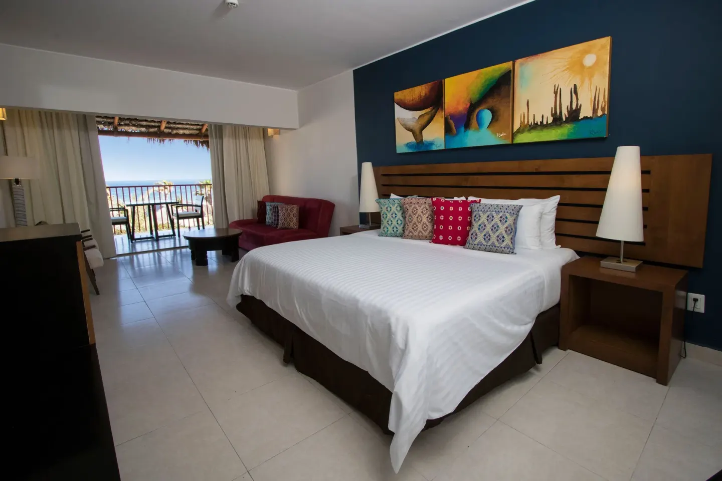 King-bed ocean view room with sitting area at Grand Decameron Los Cabos.