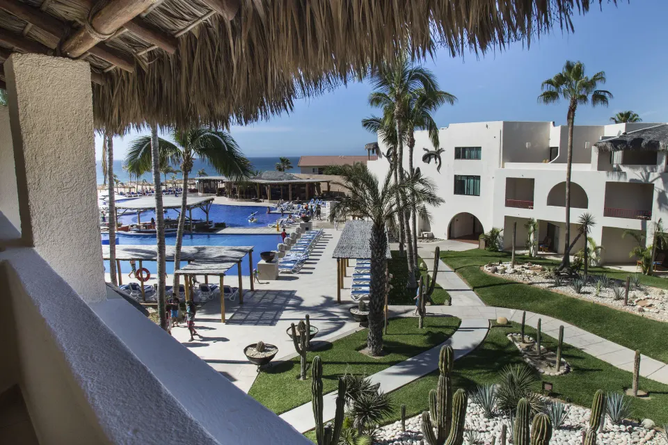 Standard Room balcony view over the pool and gardens at Grand Decameron Los Cabos.