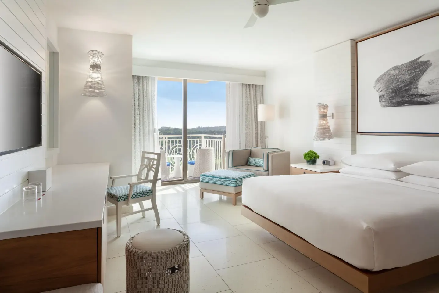 King guest room with balcony, desk, and lounge chair at Grand Hyatt Baha Mar.