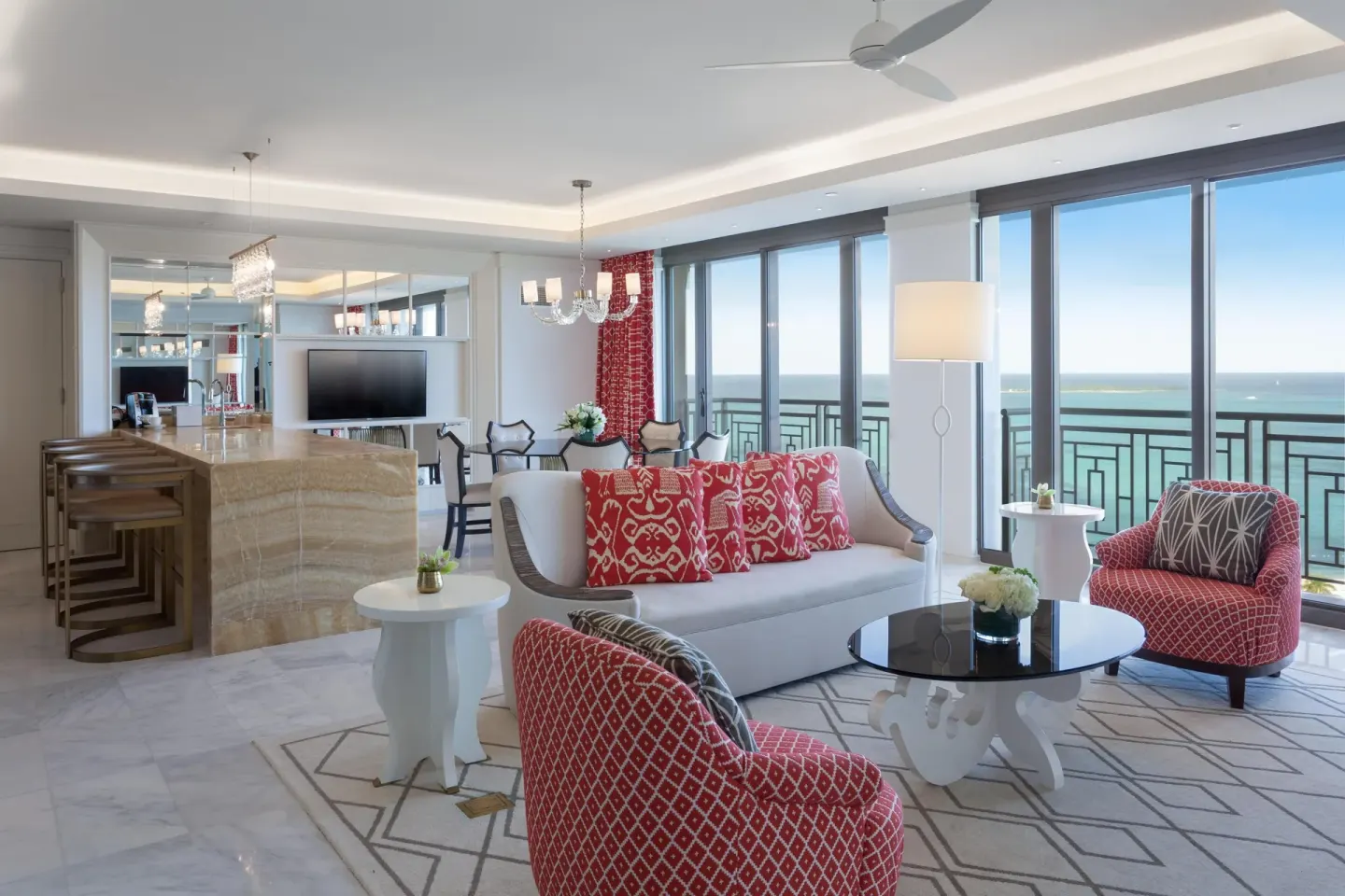 Oceanfront suite living room with red chairs at Grand Hyatt Baha Mar.