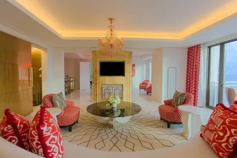 Suite lounge with patterned red seating and ocean balcony at Grand Hyatt Baha Mar.