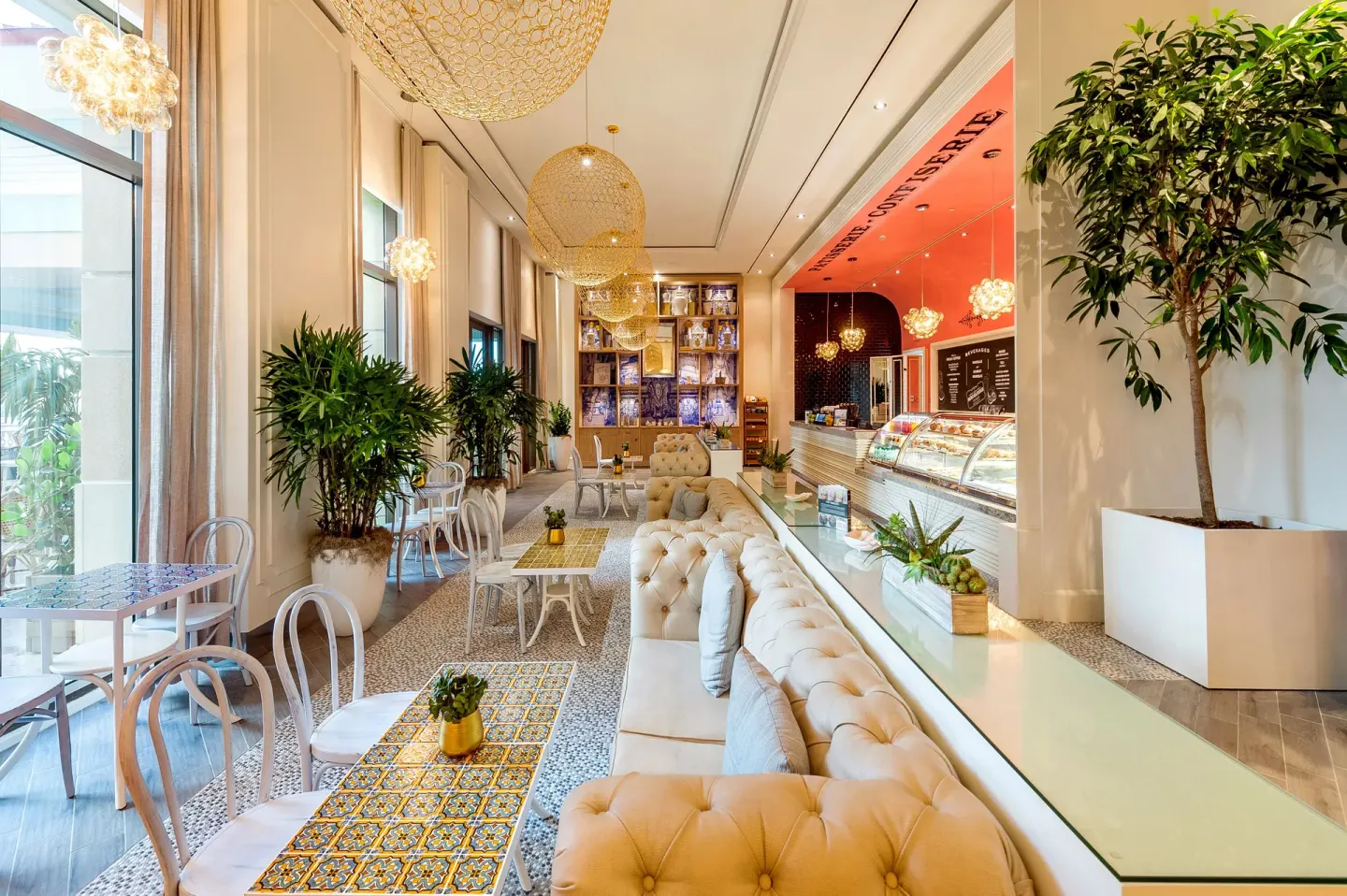 Café interior with tufted seating, tile tables, and a pastry counter at Grand Hyatt Baha Mar.