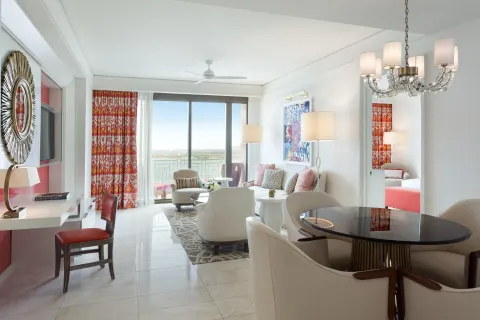 Deluxe one-bedroom residence living and dining area with balcony at Grand Hyatt Baha Mar.