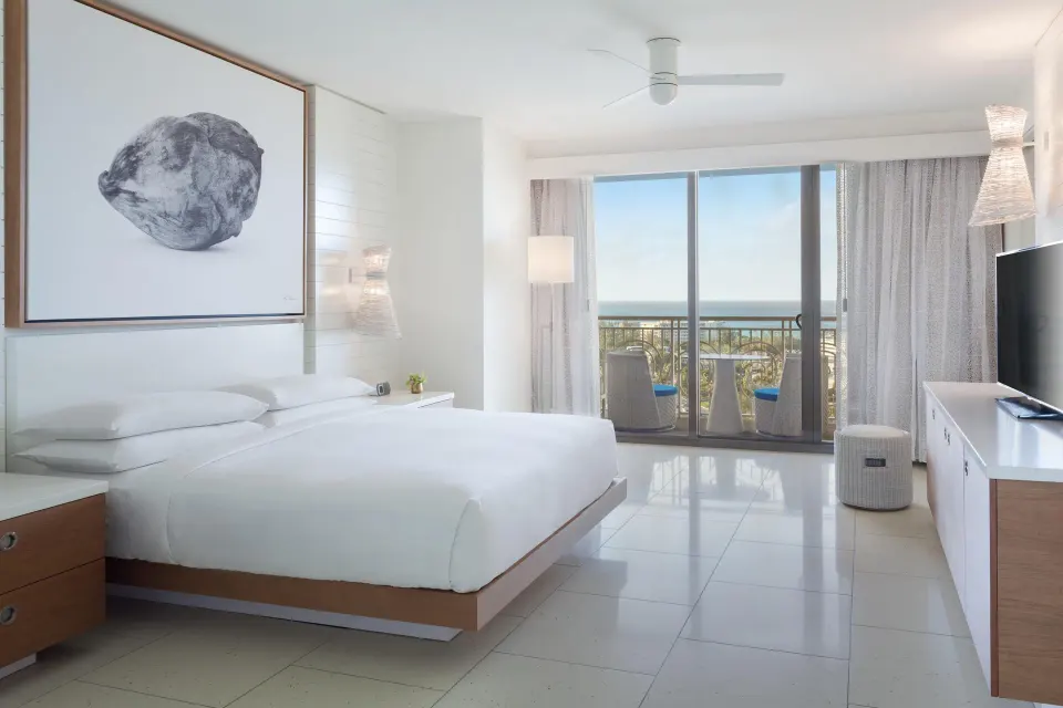 King bed and balcony in a Deluxe Room Ocean View residence at Grand Hyatt Baha Mar.