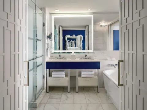 Grand Room marble bathroom with double vanity, tub, and glass shower at Grand Hyatt Baha Mar.