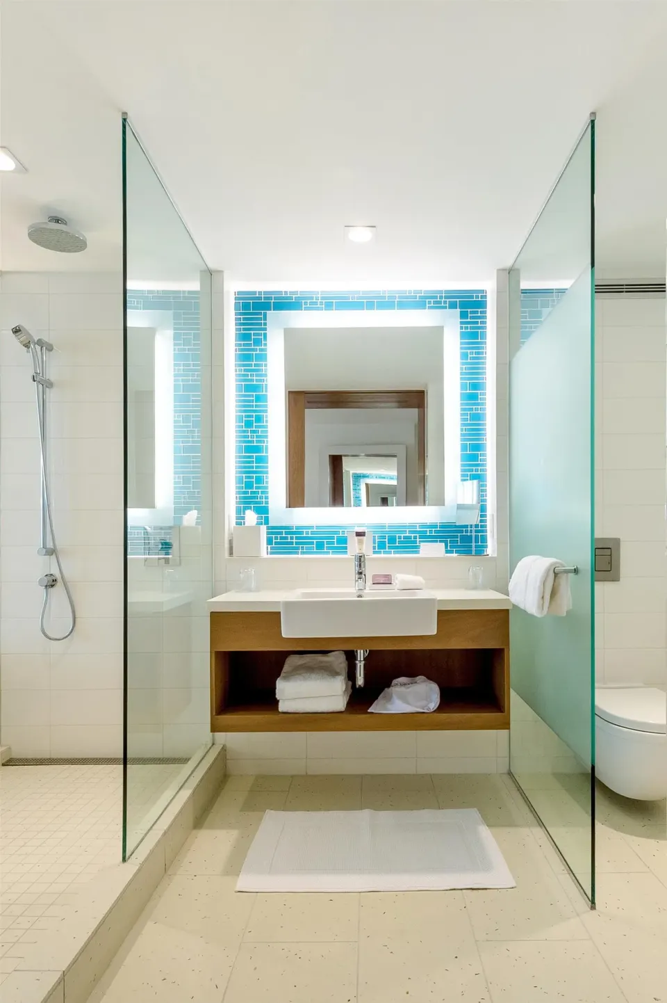 Grand Room bathroom with centered vanity, glass shower, and toilet area at Grand Hyatt Baha Mar.