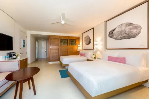 Grand Room at Grand Hyatt Baha Mar with two double beds, sofa, table, TV, and entryway.