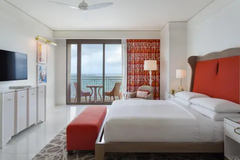 King bedroom with balcony seating and ocean view in a residence at Grand Hyatt Baha Mar.