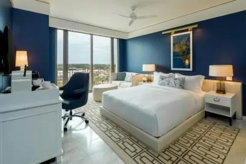 King bedroom with balcony and desk in a residence at Grand Hyatt Baha Mar.