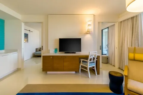 Living area with TV, desk, and bedroom doorways in a residence at Grand Hyatt Baha Mar.
